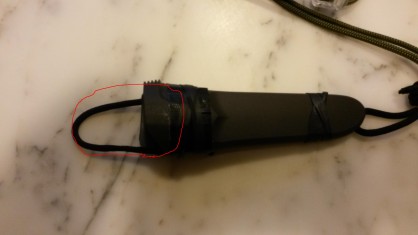 en rouge, la paracorde dépliée permettant de la fixer à la ceinture<br />notez la présence de chambre a air de part et d'autre de l'étui permettant également de fixer l'étui en mode horizontal à la ceinture